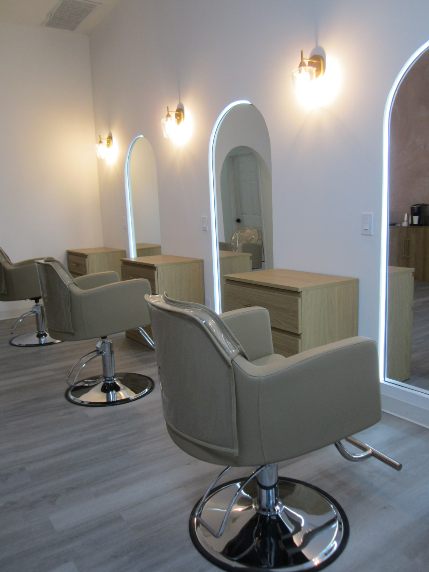 Modern salon styling stations with arched mirrors
